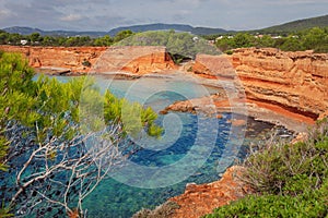 The Caleta Beach in Ibiza, with its red earth