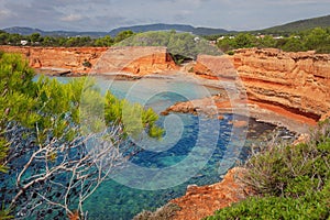The Caleta Beach in Ibiza, with its red earth photo