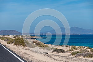 Caleta del bajo, corralejo grandes playas white sandy beach with blue water near Corralejo touristic town on north of photo