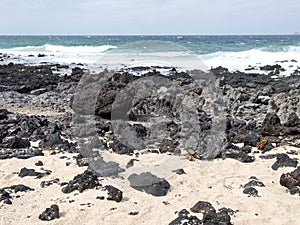 Caleta del Mojan Blanco, white sand and lava rocks