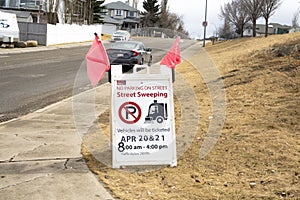 A sign with the text: NO PARKING ON STREET, Street SweepingVehicles will be ticketed APR