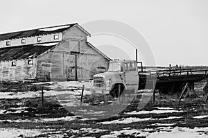 Abandoned old truck and barn in the prairie