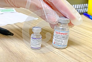 A Healthcare worker holding a pfizer and a Moderna vial Covid-19 vials vacines at a