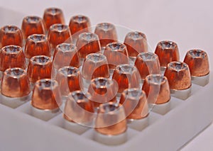 .40 caliber hollow point bullets lined up in a plastic case