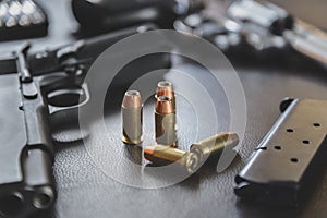 .45 Caliber hollow point bullets near handgun and magazine