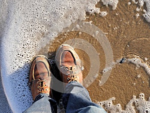 California beach shot of my boots with the sea foam lapping at my feet. For travel blogs as a banner image, graphic, social media