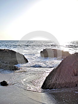 California beach with waves, tidepools, blue green water and rocks on shore. Great for travel blogs, website banners
