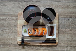 California maki roll in square plate Japanese style served with shoyu sauce and wasabi