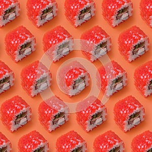 California Maki sushi rolls with caviar and masago on orange background. Minimalism top view flat lay pattern with Japanese food