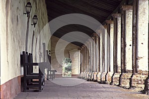 California mission hallway with columns with afternoon sun