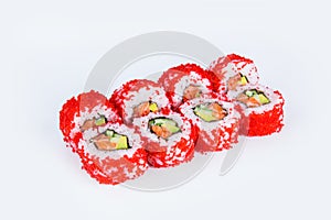 California roll wrapped in rice and red flying fish roe Tobiko caviar served on gray background with salmon fillet and cucumber