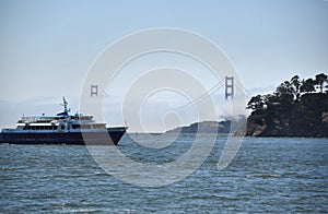 California- Tiburon- Panorama of The Golden Gate Bridge in Fog With Ferry Passing in Foreground