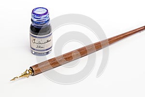 Caligraphy pen and blue ink in glass bottle