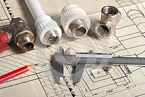 Engineer workspace concept. caliper, calipers, plumbing and flanges on the drawing