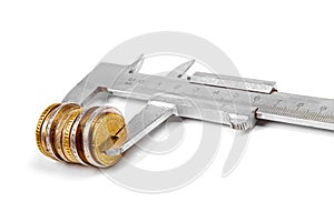 Caliper and stack of coins isolated on white