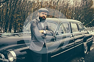 Call boy in vintage auto. Escort man or security guard. Retro collection car and auto repair by mechanic driver. Bearded