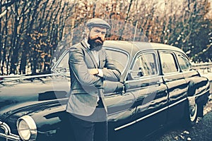 Call boy in vintage auto. Escort man or security guard. Retro collection car and auto repair by mechanic driver. Bearded