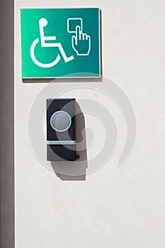 Call button for the disabled personnes. Door opener button on the wall for disabled people
