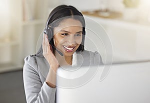 .Call center agent or CRM business woman talking on phone with headset and computer offering client support and help