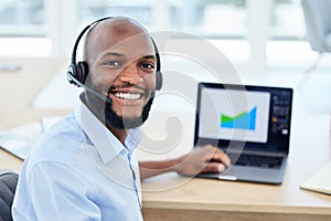 Call center agent, customer service representative and sales support staff wearing a headset and working on his laptop