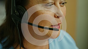 Call center agent face close-up talking on support hotline.