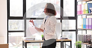 Call center agent wearing headset consults client and walks around office