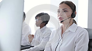 Call Center Agents Consulting Clients On Hotline At Office