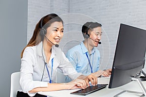 Call center agents using computers working in office