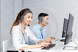 Call center agents using computers working in office