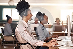 Call center, black woman and computer on desk in office for customer service, sales or support. Agent or consultant team