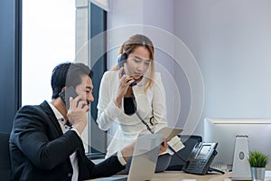 Call center business woman talking on headset. Call center worker accompanied by her team. Customer service executive working at o