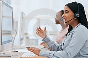 Call center, computer and woman talking at desk in telemarketing, customer service and CRM office. Female with headset