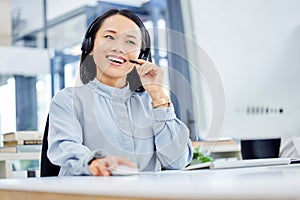 Call center, customer service and woman at computer while consulting online for CRM, contact us or sales website. Asian
