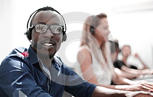 Call center employee on the background of colleagues