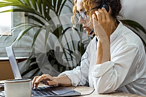 Call center employees speaking with clients assistance using headset and microphone and laptop connection. People and job. Modern