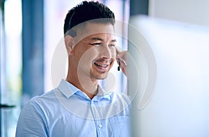 Call center, man and headset with computer, customer service and smile for telemarketing, sales and help. Company, agent