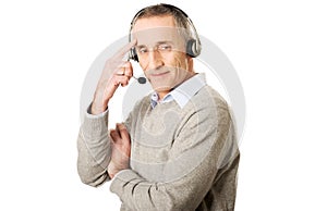 Call center man wearing a headset touching head