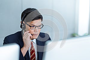 Call center man working care customer service wearing headphone talking .with customer at call center office.Support Customer Team