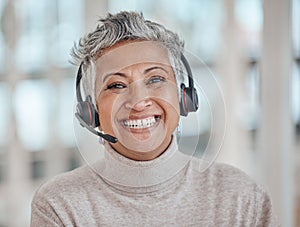 Call center, mature and face of woman with headphones in office for telemarketing, support or contact. Smile, portrait