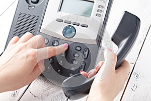 Call center or office phone concept, female finger press number on phonepad