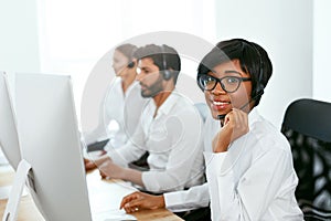 Call Center Operator With Colleagues At Workplace