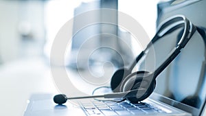 Call center operator desktop. Close-up of a headset on a laptop. Help desk. Workplace of a support service employee