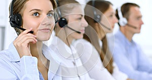 Call center operator in headset while consulting client. Telemarketing or phone sales