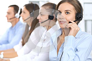 Call center operator in headset while consulting client. Telemarketing or phone sales. Customer service and business