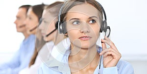 Call center operator in headset while consulting client. Telemarketing or phone sales. Customer service and business