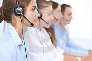 Call center operator in headset while consulting client. Telemarketing or phone sales. Customer service and business