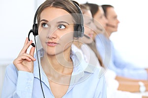 Call center operator in headset while consulting client. Telemarketing or phone sales. Customer service and business