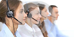 Call center operator in headset while consulting client. Telemarketing or phone sales. Customer service and business