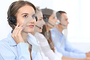 Call center operator in headset while consulting client. Telemarketing or phone sales. Customer service and business