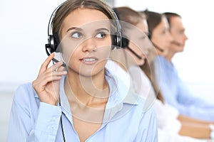 Call center operator in headset while consulting client. Telemarketing or phone sales. Customer service and business